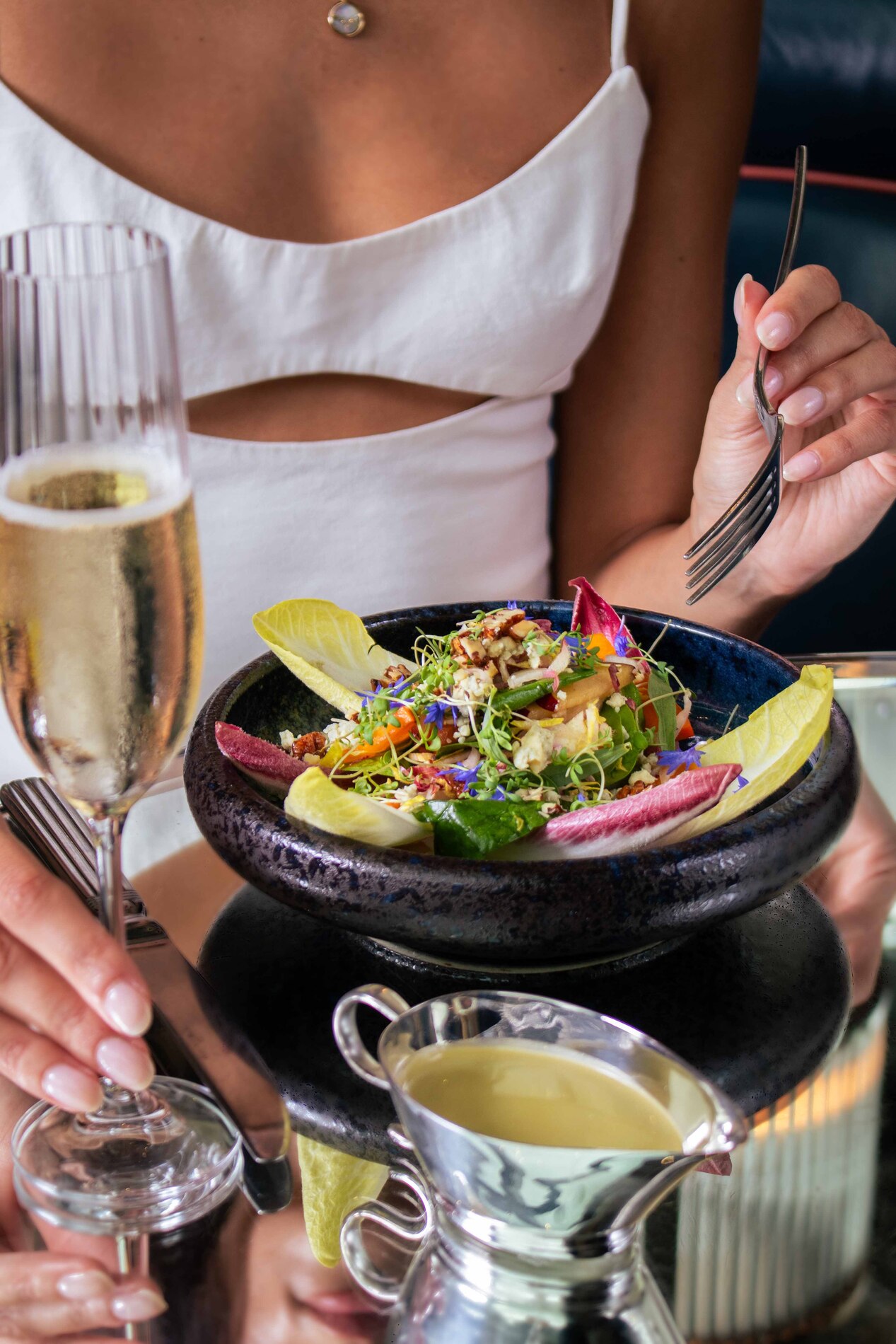 Guest having a dinner and a glass of Champagne at Brasserie of Light.