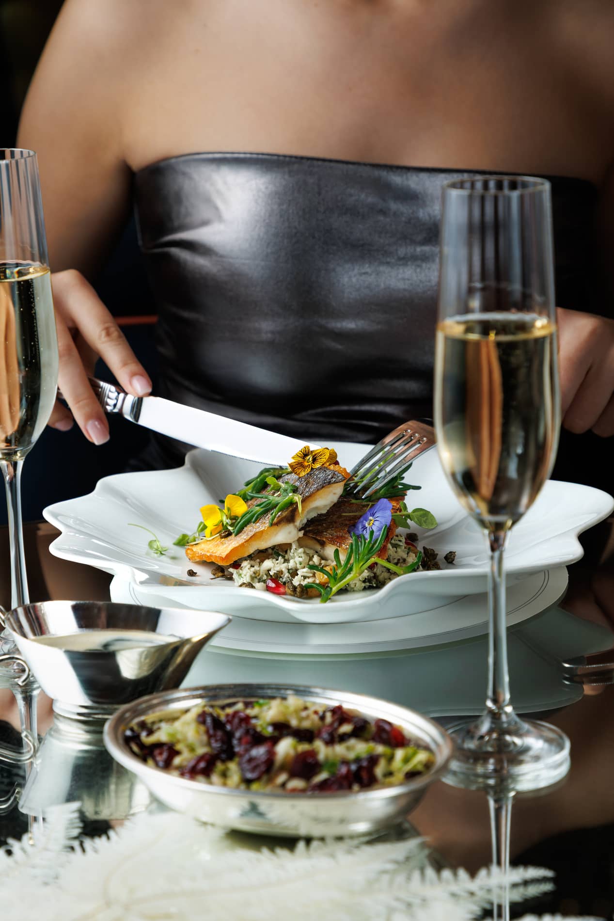 Guest enjoying a dinner with a glass of Champagne at Brasserie of Light in London.
